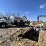 A G-Crete C60 volumetric mixer backs up to place concrete around a sewer transmission line near Seguin, Texas.
