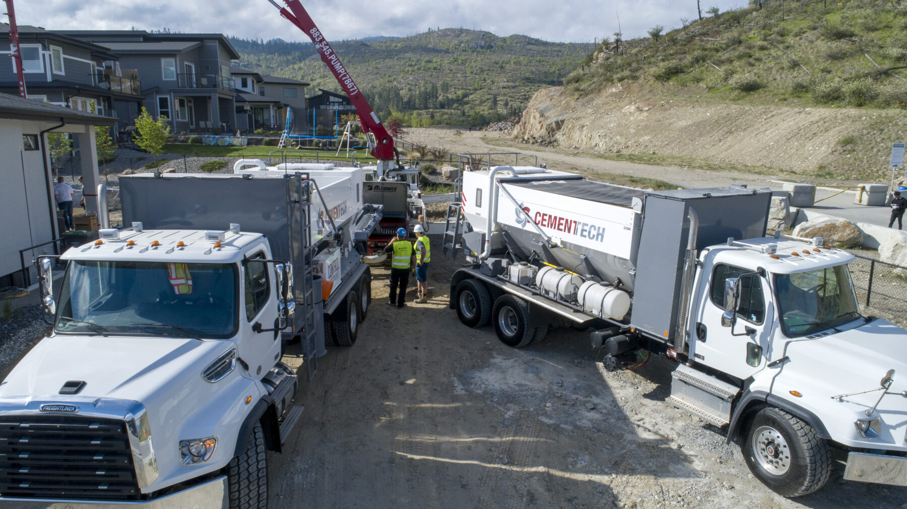 Two volumetric mixers delivering concrete in British Columbia